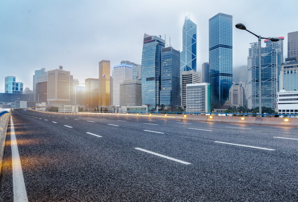 city empty traffic road with cityscape in background